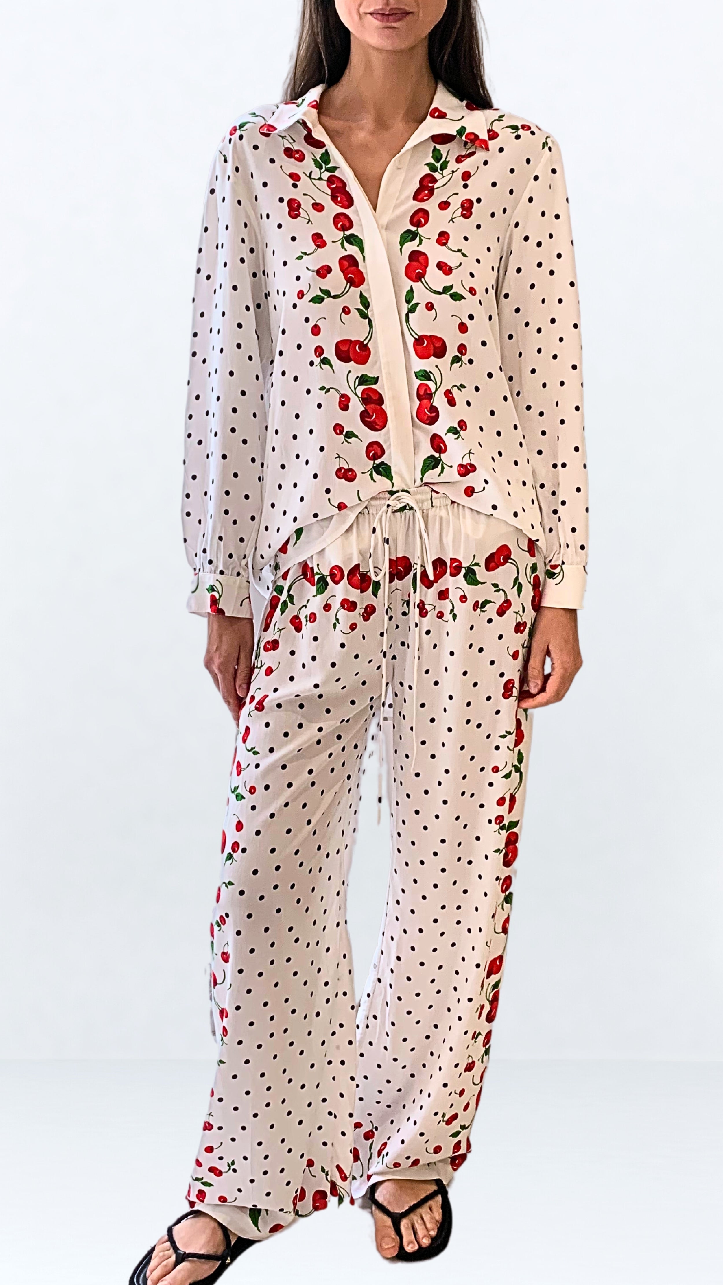Leslie Amon Jaw String Cherry Pants. White drawstring loose fitting pants with an original cherry and polka dot print. Adjust waist. Shown on model facing front.