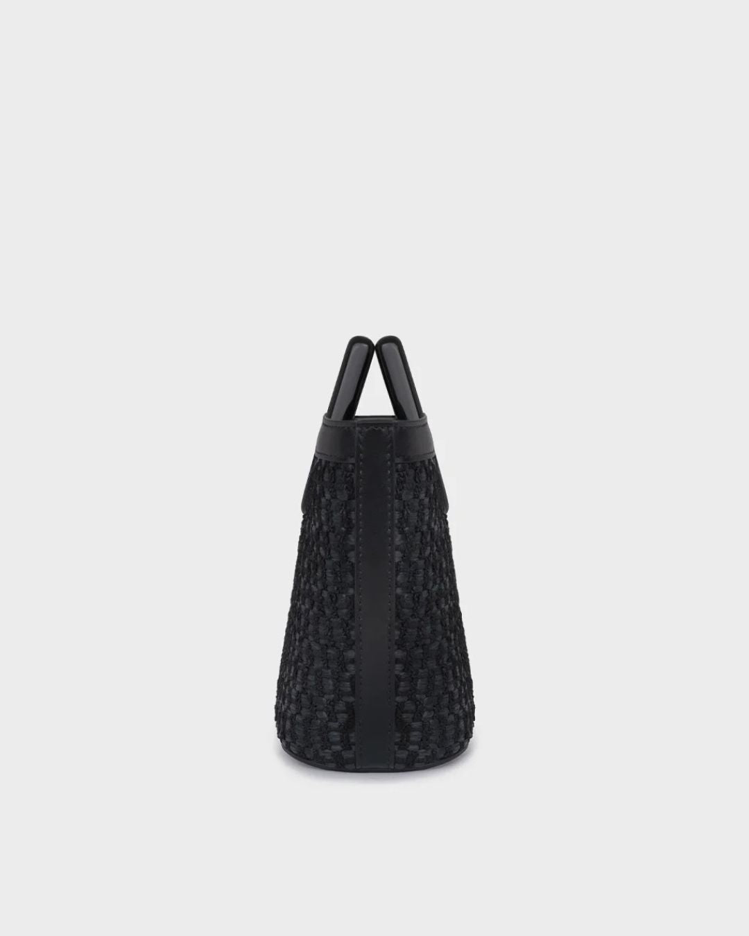 Marina Raphael Baby Riviera black raffia bag, side profile view showing woven body and black leather corner trim