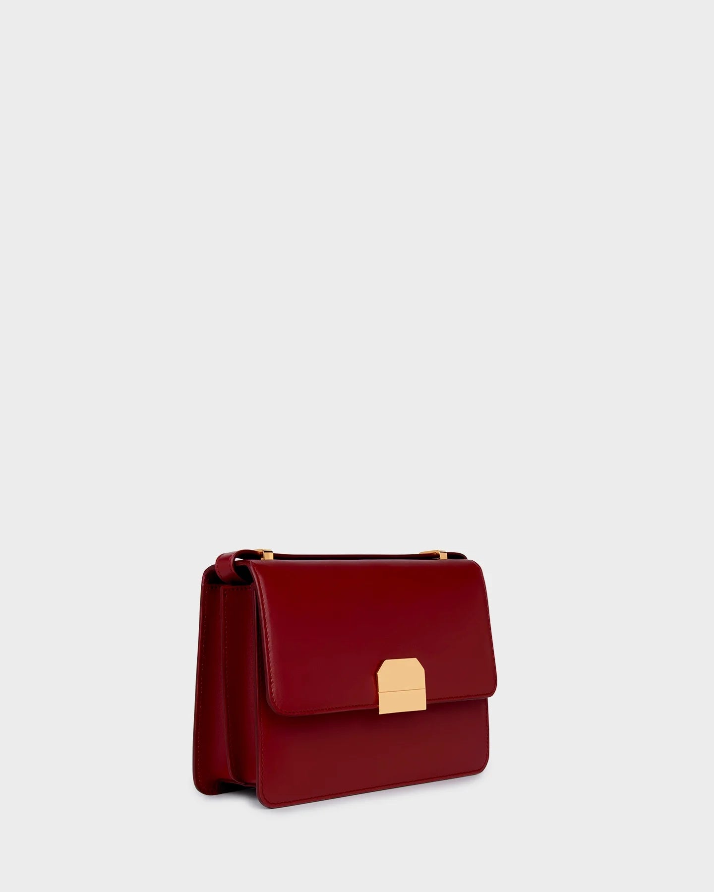 Marina Raphael Alex Bag in burgundy nappa leather, three-quarter front view with gold hardware.