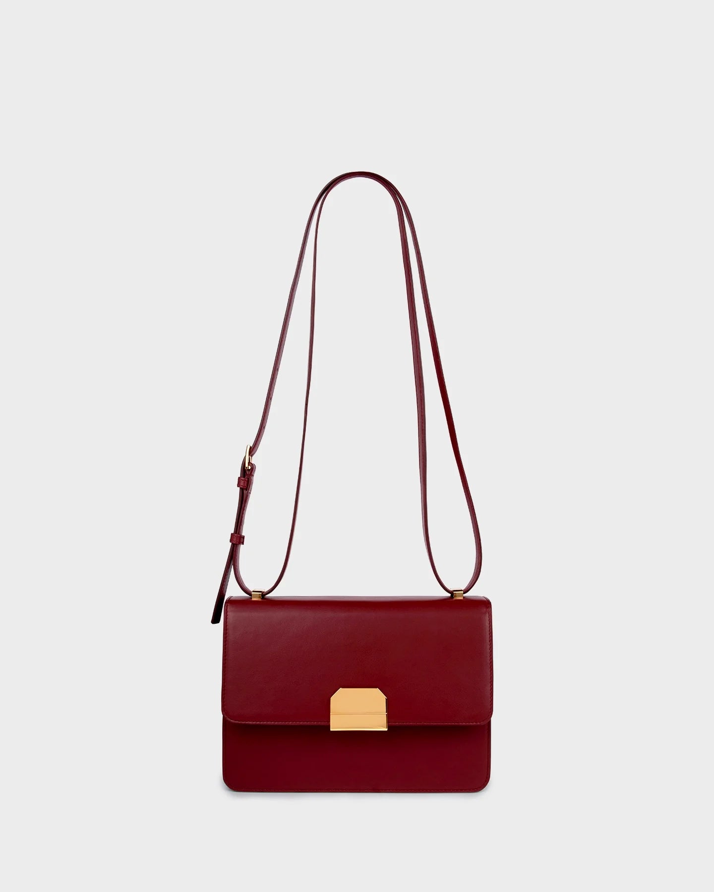 Straight-on view with adjustable burgundy leather strap attached.