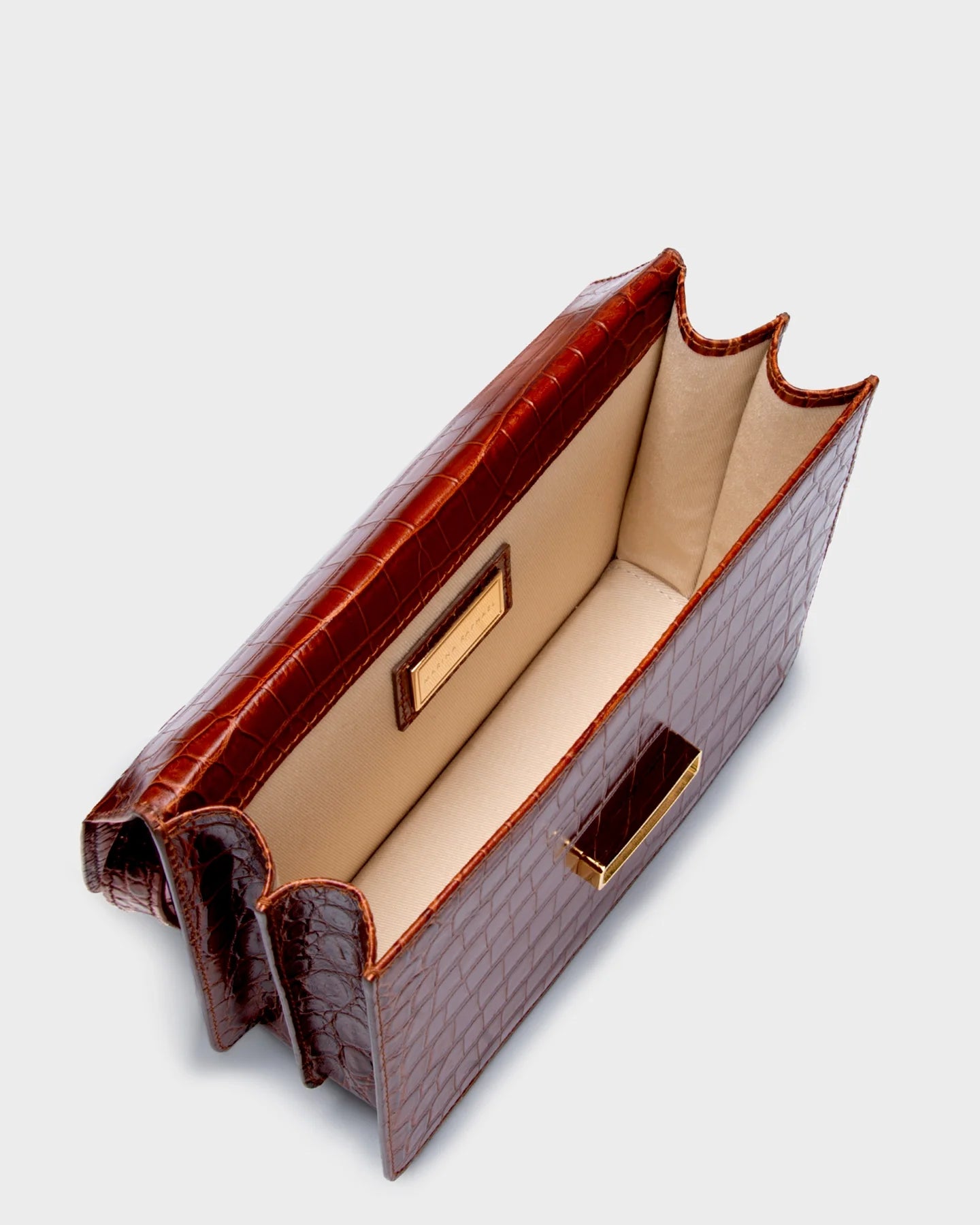Top-down view of the Alex bag showing dual compartments and beige lining.