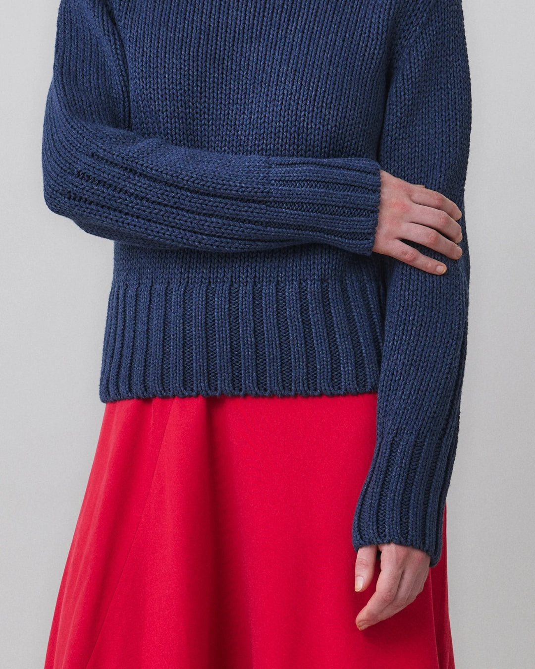  Close-up of ribbed hem and forearm stripe detail on MARTAN Floyd Sweater in anthracite blue