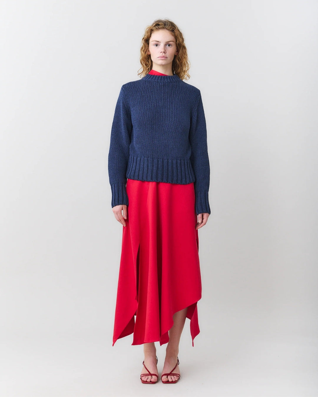 MARTAN Floyd Sweater in anthracite blue, full length front view styled with red asymmetric skirt