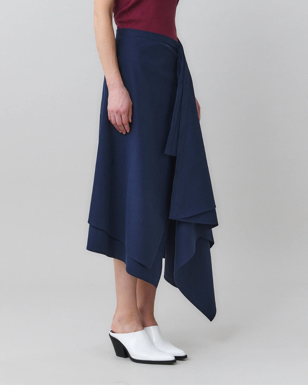 MARTAN Laurie Skirt, three-quarter front view showing draped panel and layered hem