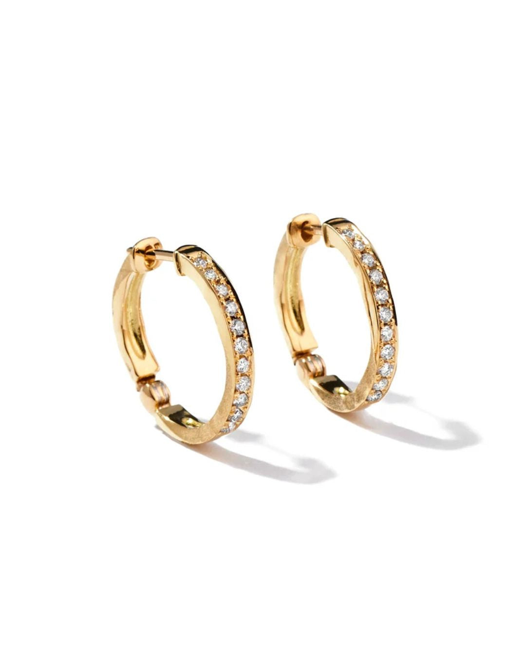 Three-quarter view of the Milamore En Pavé Hoops with natural diamonds and textured yellow gold sides.