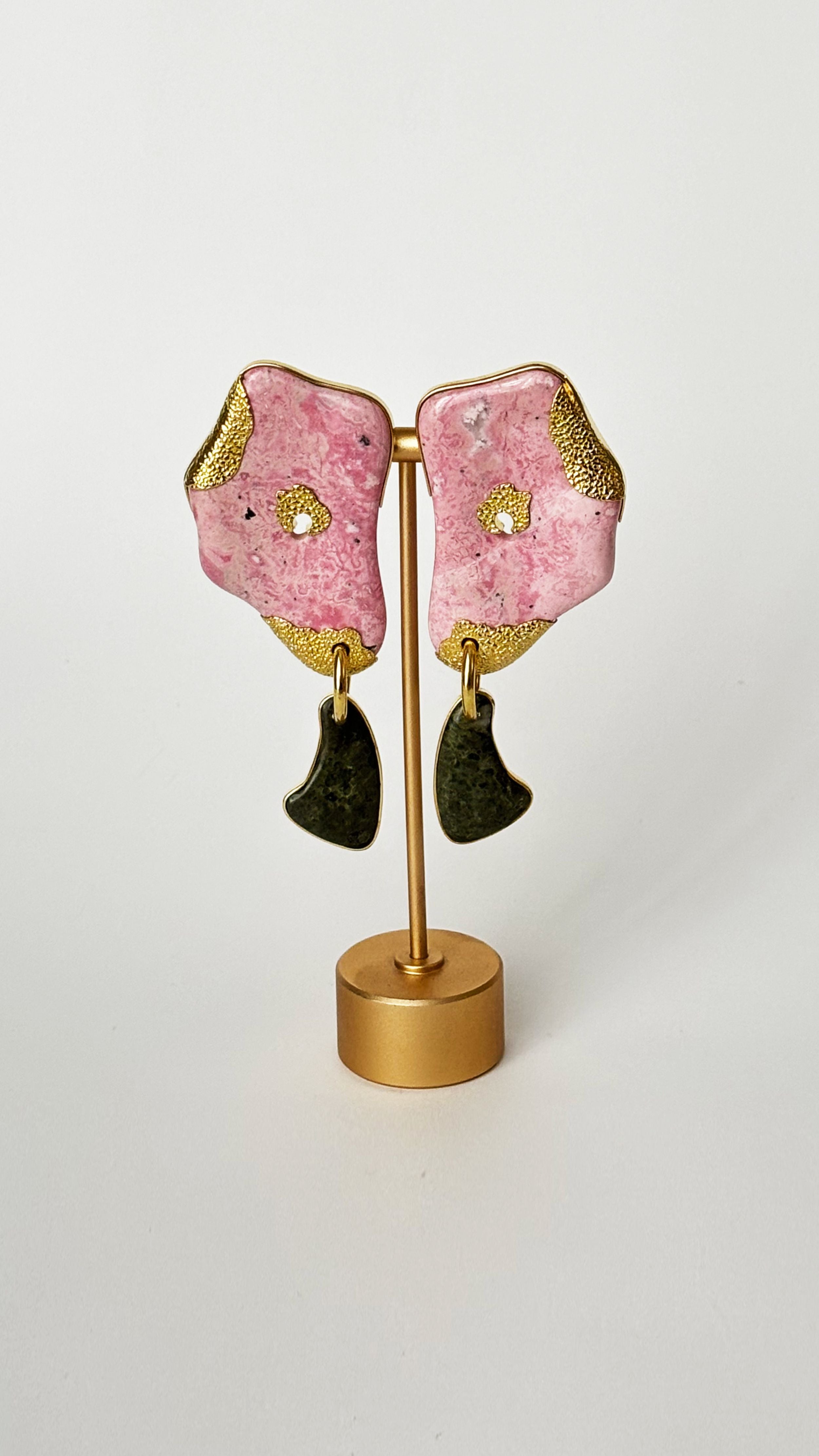 Monica Sordo Profundo Earrings in Pink Rhodonite. Product photo of pair of earrings in organic shape with pink rhodonite body and green drops. 24K gold plated drop earrings.