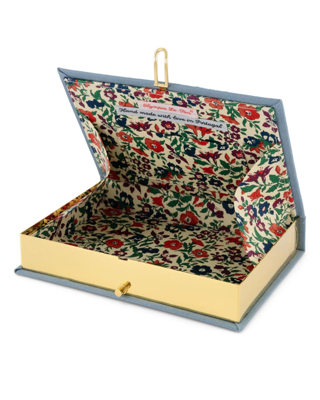 Interior view of the clutch open, showing the gold-tone stainless steel frame, kiss-lock clasp, and unique multicoloured floral printed fabric lining with Olympia Le-Tan label reading "Hand made with love in Portugal."