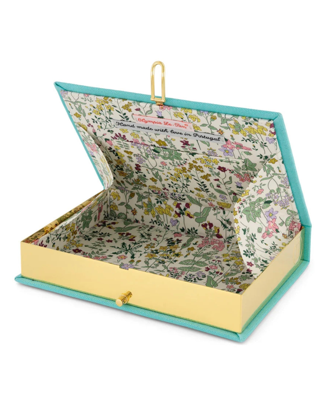 Interior view of the clutch open, showing the gold-tone stainless steel frame, kiss-lock clasp, and unique multicoloured wildflower printed fabric lining with Olympia Le-Tan label reading "Hand made with love in Portugal."