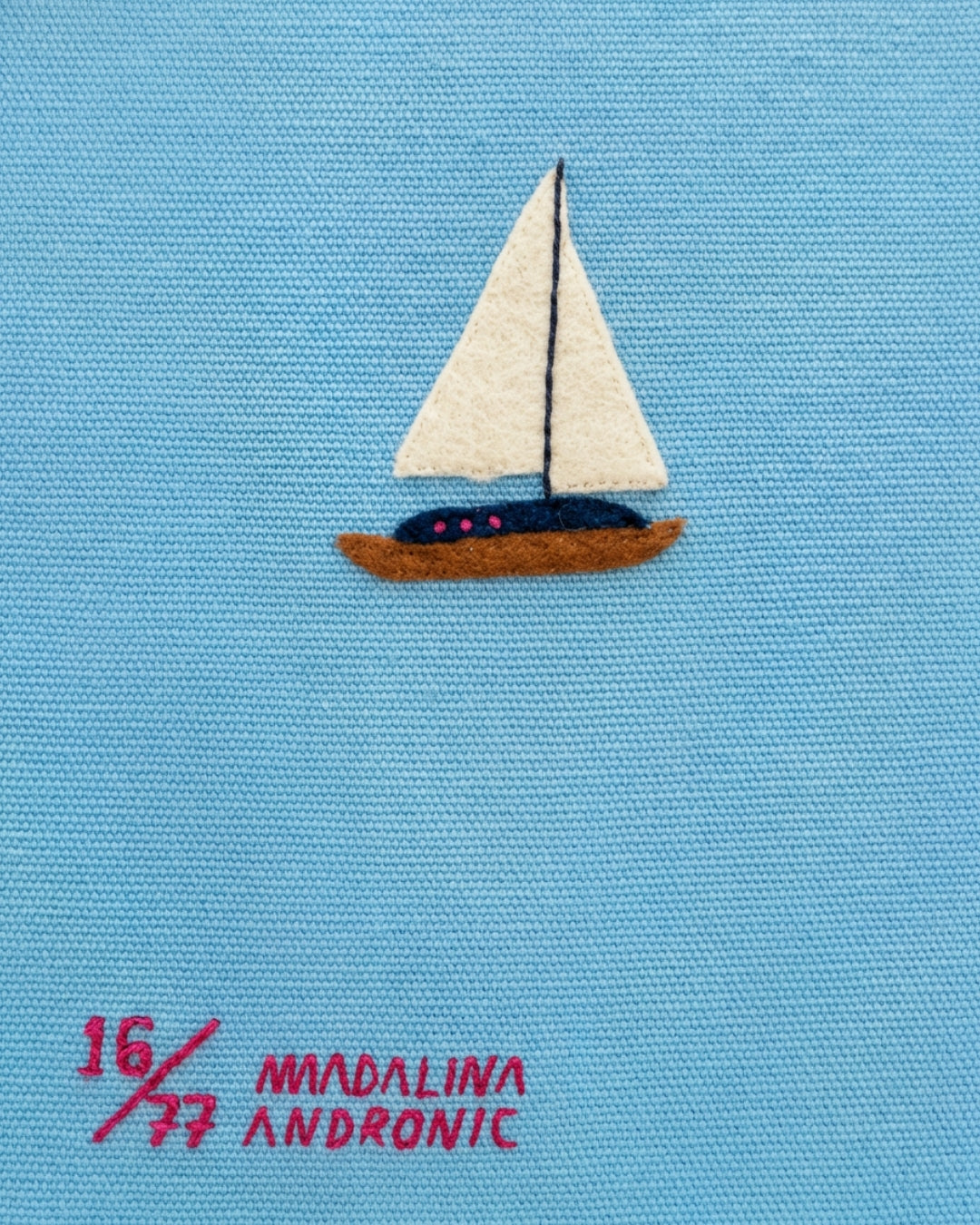 Reverse of Olympia Le-Tan Marbella clutch showing felt sailboat appliqué and Madalina Andronic numbered artist signature