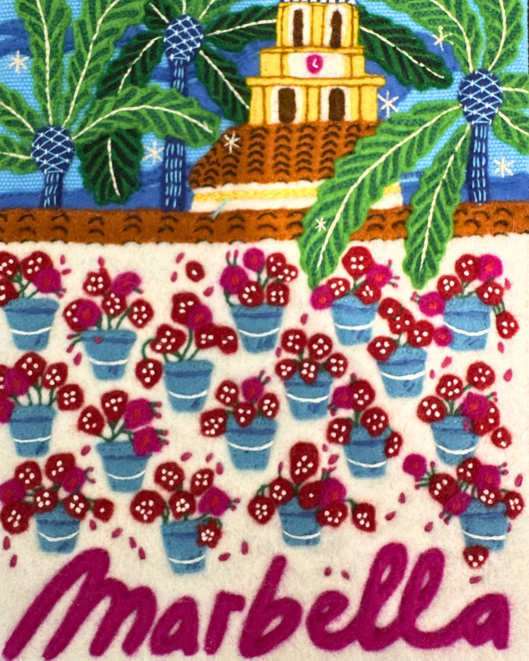 Close-up of hand-embroidered geraniums and Marbella lettering detail on Olympia Le-Tan book clutch