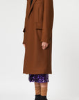 Plan C Chestnut Wool Overcoat. Classic but with a modern esthetic with coat jacket. Chestnut brown Italian wool with double layers. Midi length and long sleeves. Shown on model facing to the side.