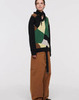 Plan C Color Block Sweater with Scarf. Wool and cashmere blend sweater made in Italy. With Green, pale yellow, ecru and black geometric patterns across the front and a sold black back. Comes with a built in scarf that can be worn tied or open. Shown on model facing to the side.