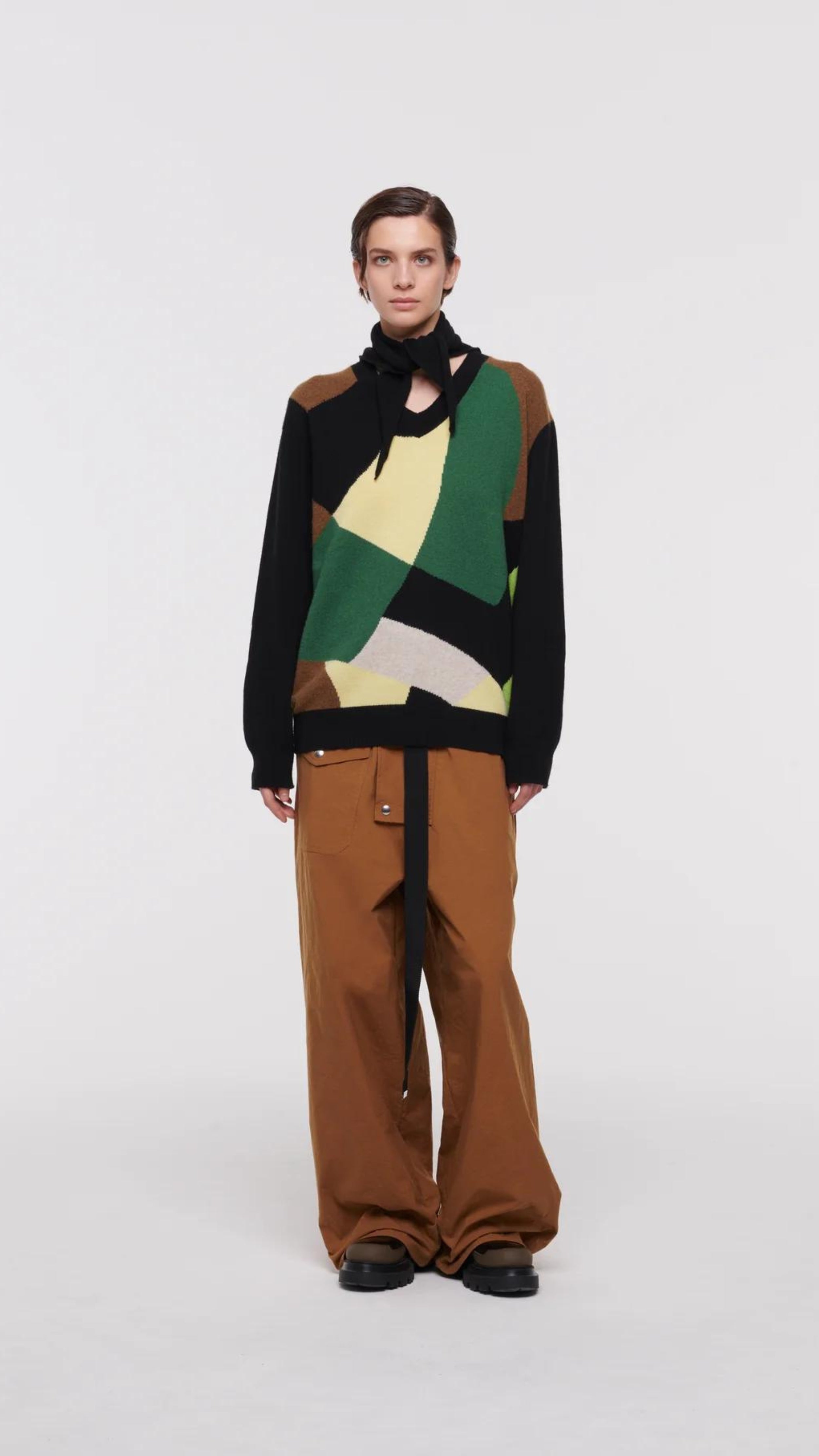Plan C Color Block Sweater with Scarf. Wool and cashmere blend sweater made in Italy. With Green, pale yellow, ecru and black geometric patterns across the front and a sold black back. Comes with a built in scarf that can be worn tied or open. Shown on model facing front.