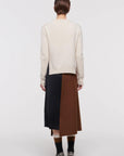 Plac C Contrast Midi Skirt. Paneled midi skirt in sofy brown chestnut wool and black satin. Modern and classic in shape and colors. Shown here on the model facing the back.