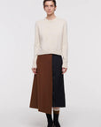 Plac C Contrast Midi Skirt. Paneled midi skirt in sofy brown chestnut wool and black satin. Modern and classic in shape and colors. Shown here on the model facing front.