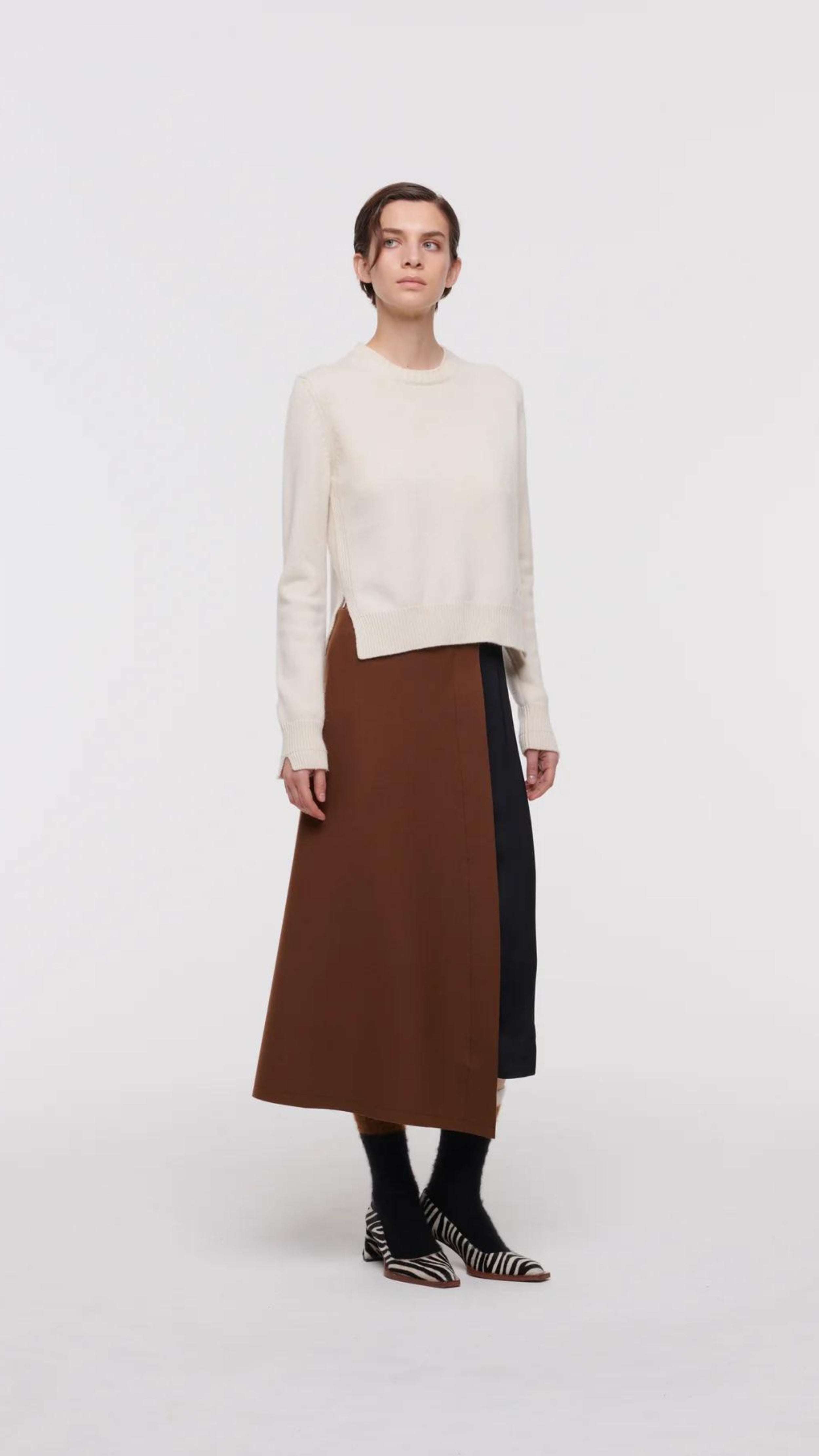 Plac C Contrast Midi Skirt. Paneled midi skirt in sofy brown chestnut wool and black satin. Modern and classic in shape and colors. Shown here on the model facing front.