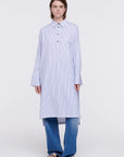 Plan C Striped Cotton Poplin Shirt Dress Classic yet modern shirt dress made from soft cotton poplin in pale blue and white stripes. It has three silver buttons, a collared neckline, long cuffs, and a breast pocket. It's designed with a relaxed fit and side pockets. Shown on model facing front