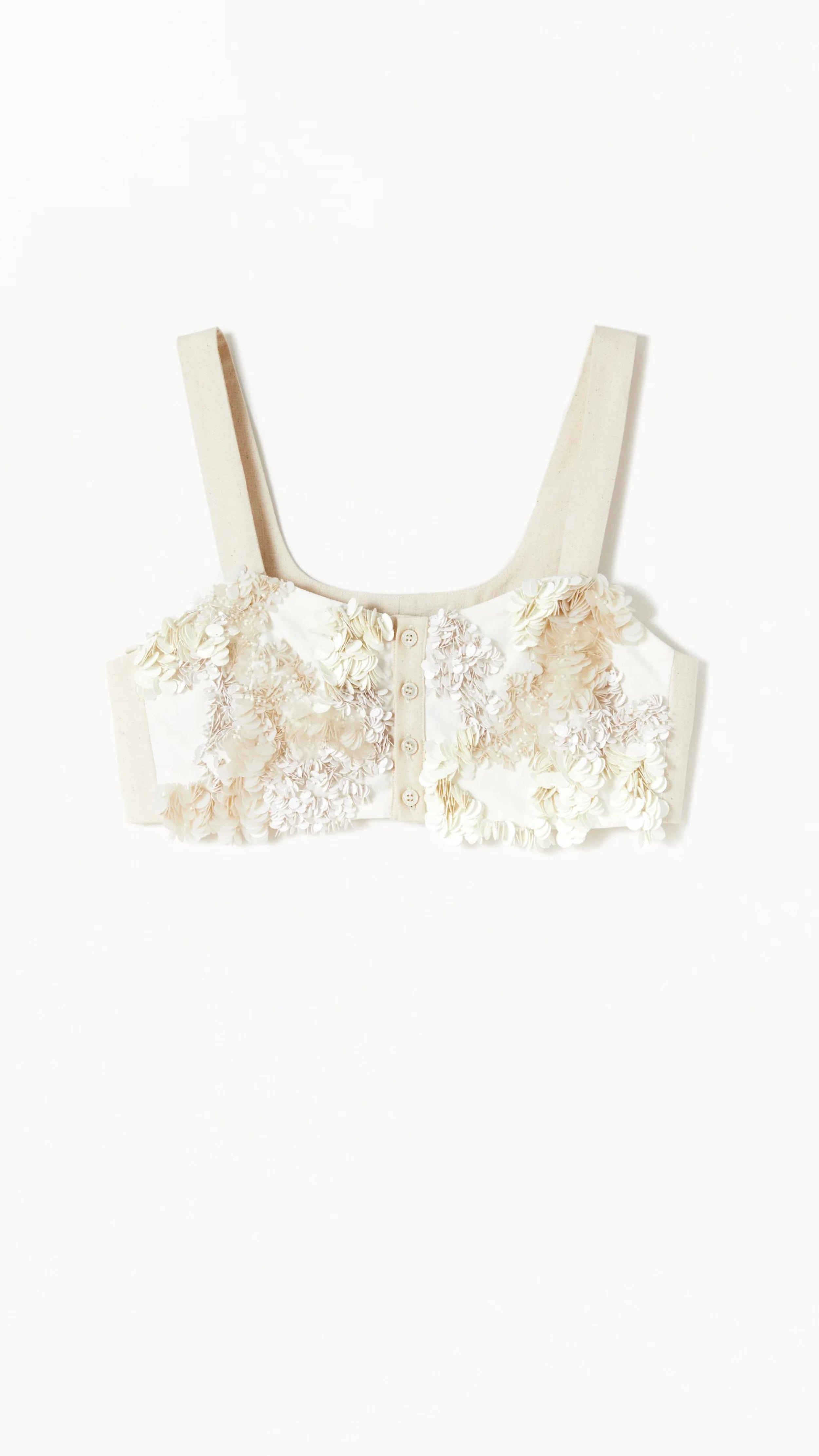 Plan C, Cream Sequinned Corset Top. Bra style layering piece. Soft panama cotton adorned with sequins, a sweetheart neckline and front button closure. Product photo shown from the front.