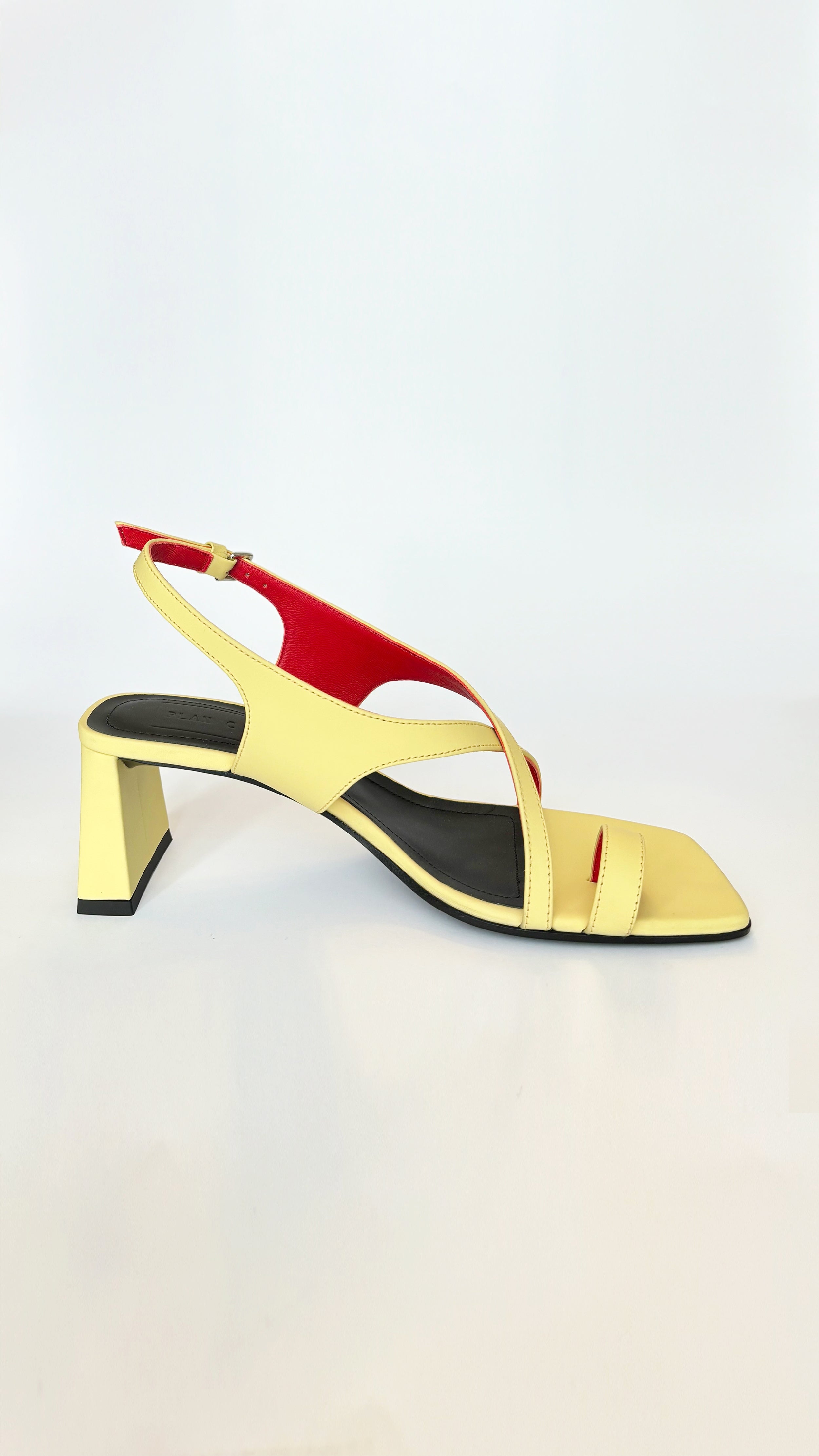 Plan C Crisscross Toe-Loop Slingback Sandals. In yellow leather exterior with a pop of red interior. It features one toe loop, open toe heeled sandal with a criss cross of leather acorss the top. Stack heel in the back. Pair shown showing side interior view.