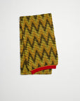 Plan C Jacquard Knit Oversize Scarf in pistachio, black and ochre colored chevron V pattern. Pop of red at the trim. Super oversized made from soft alpaca and wool blend. Photo shown folded. 