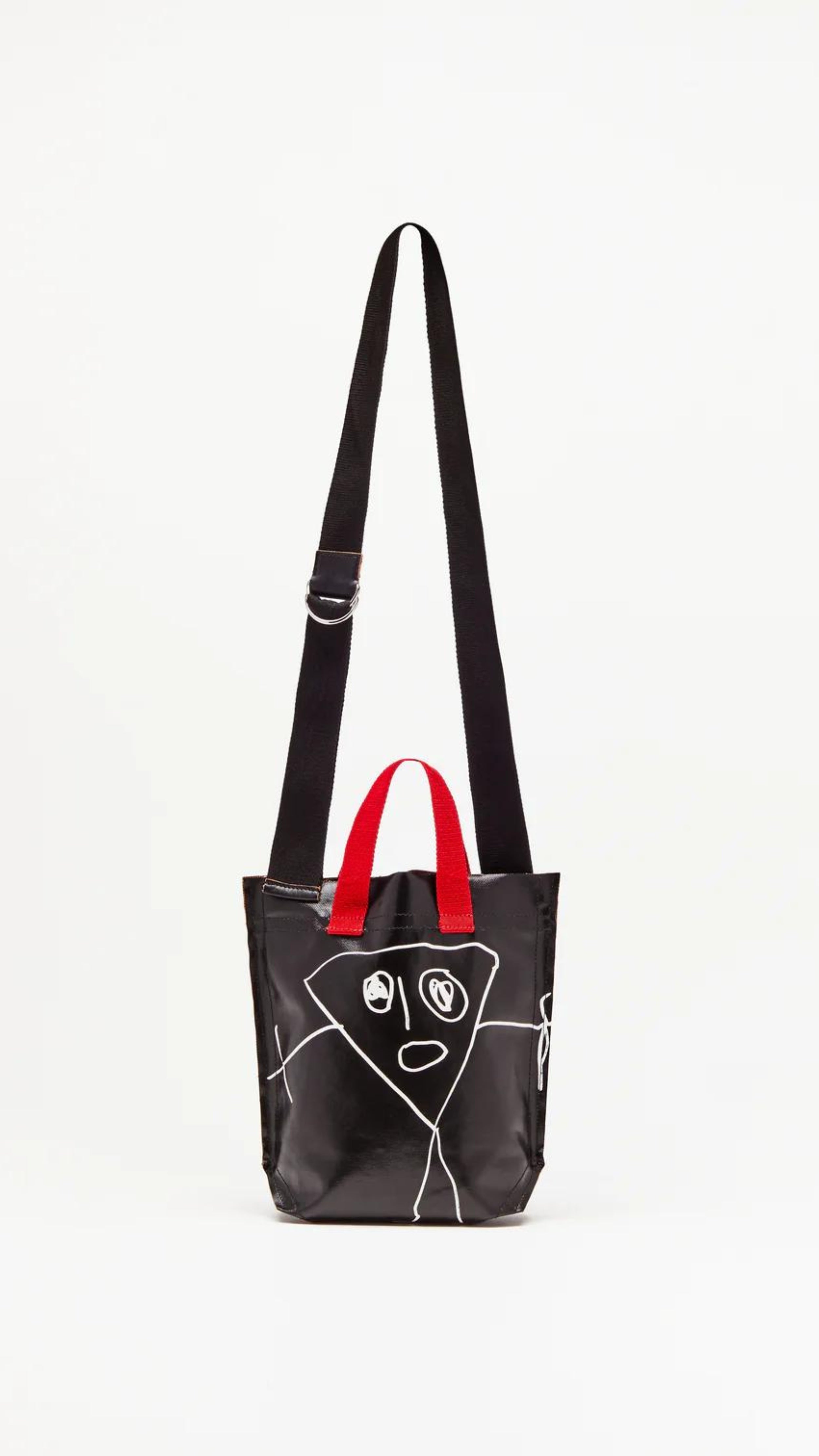 Plan C Pili and Bianca Black Mini Shopper. Coated canvas mini shopper style bag with whimsical drawings on either side. Completed with a red handle strap and a long black strap. Shown from back view.
