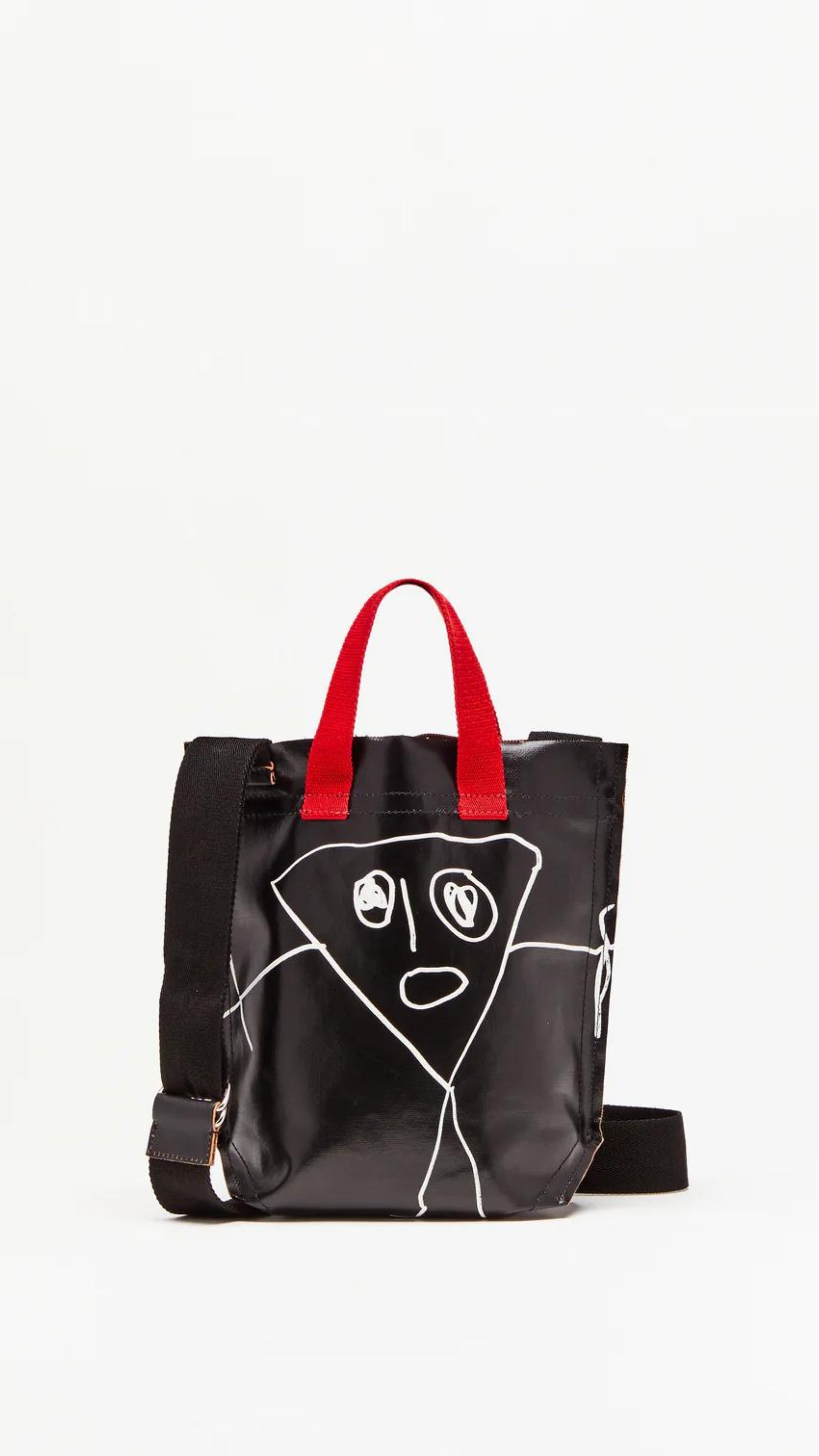 Plan C Pili and Bianca Black Mini Shopper. Coated canvas mini shopper style bag with whimsical drawings on either side. Completed with a red handle strap and a long black strap. Shown with straps.