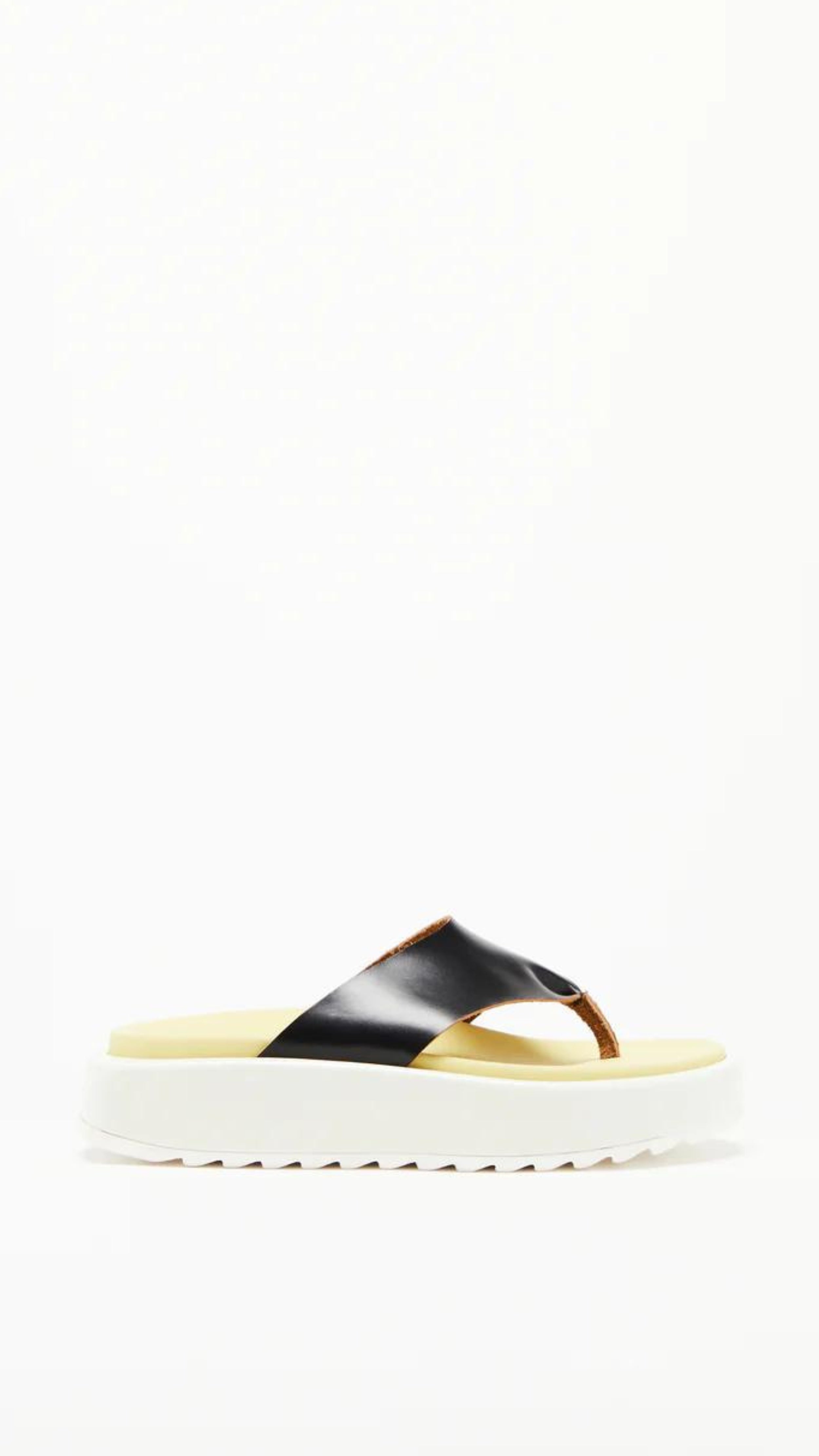 Plan C Platform Thong Sandal. Made in Italy the thong leather detail is in black with the sole interior in a pale yellow. With a slight platform, the outer edges are in white. Photo shown from the side.