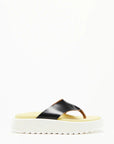 Plan C Platform Thong Sandal. Made in Italy the thong leather detail is in black with the sole interior in a pale yellow. With a slight platform, the outer edges are in white. Photo shown from the side.