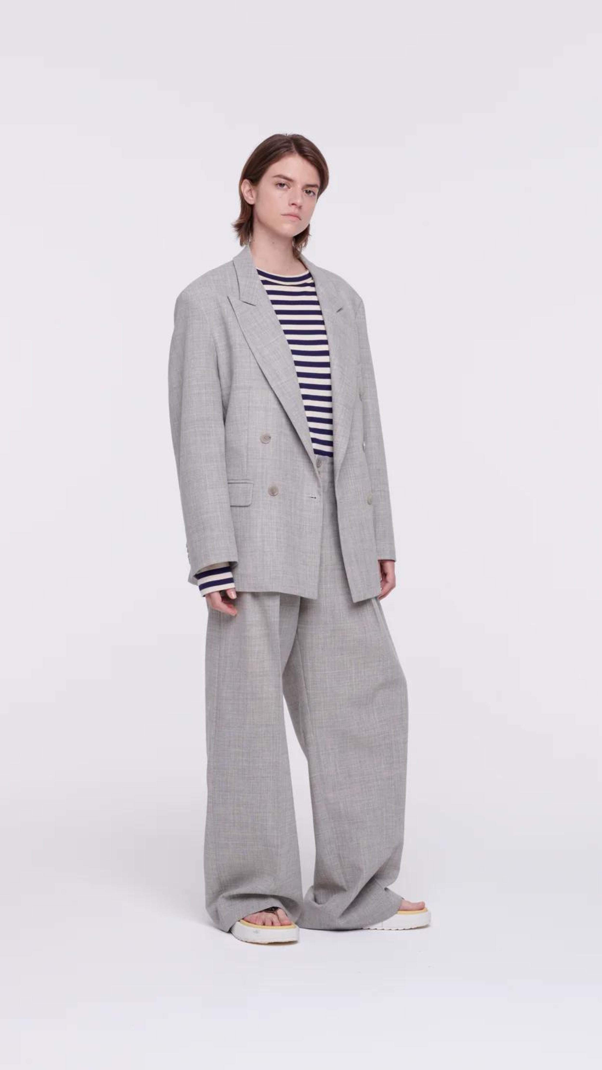 Plan C Pleated Melange Wide Leg Pants. tailored-cut and high-rise fit and wide leg trouser. With double pleating, button fastening closure, and pockets. Made in Italy from a light weight grey melange wool panama weave. Shown on model.
