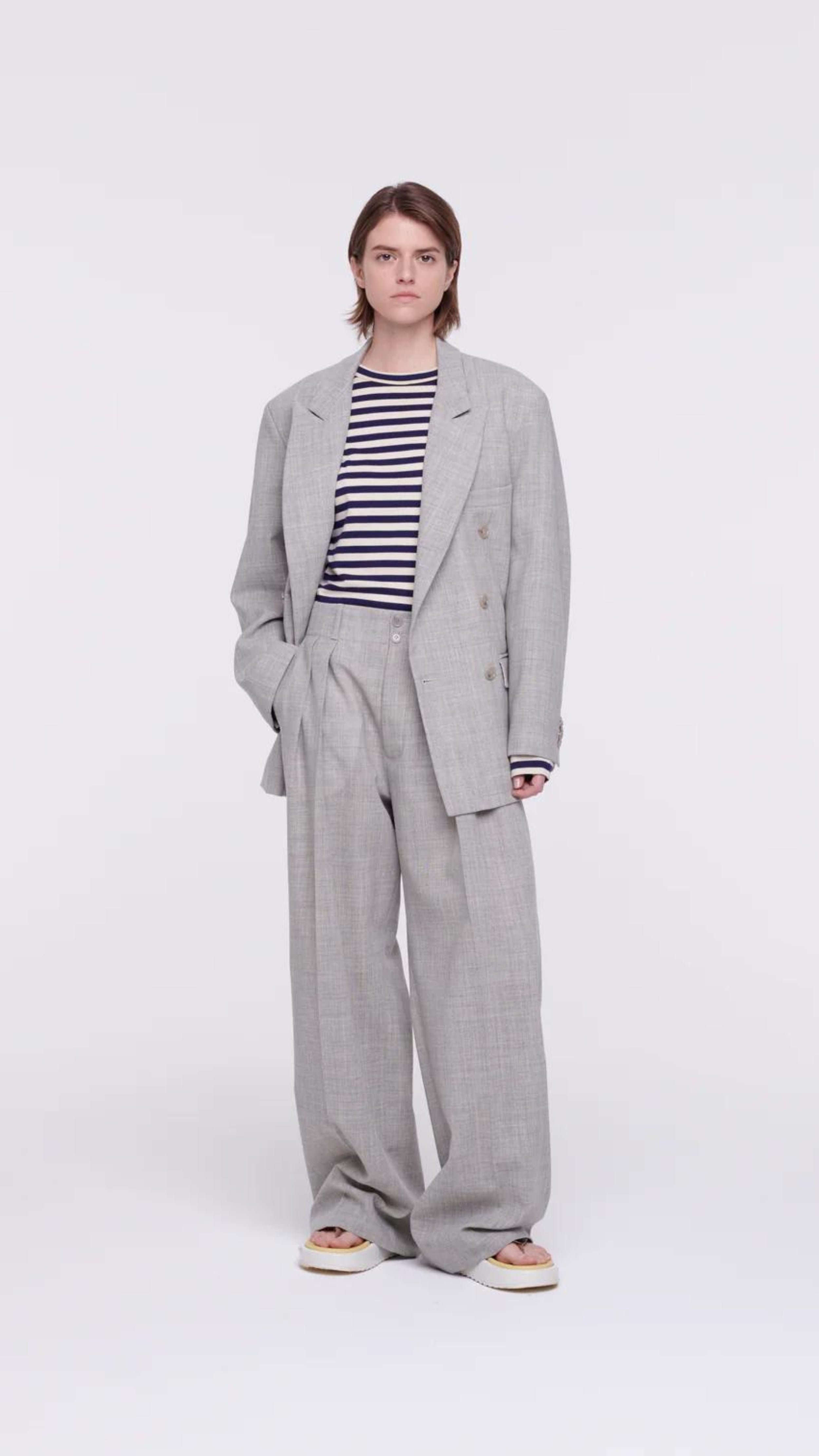 Plan C Pleated Melange Wide Leg Pants. tailored-cut and high-rise fit and wide leg trouser. With double pleating, button fastening closure, and pockets. Made in Italy from a light weight grey melange wool panama weave. Photo shown on model.