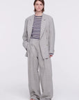 Plan C Pleated Melange Wide Leg Pants. tailored-cut and high-rise fit and wide leg trouser. With double pleating, button fastening closure, and pockets. Made in Italy from a light weight grey melange wool panama weave. Photo shown on model.