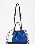 Plan C Small Coulisse Shopper Bag in soft color blocked leather of white, blue and black. zippered top with a drawstring, double handles, and a detachable crossbody strap. Shown from the back view.