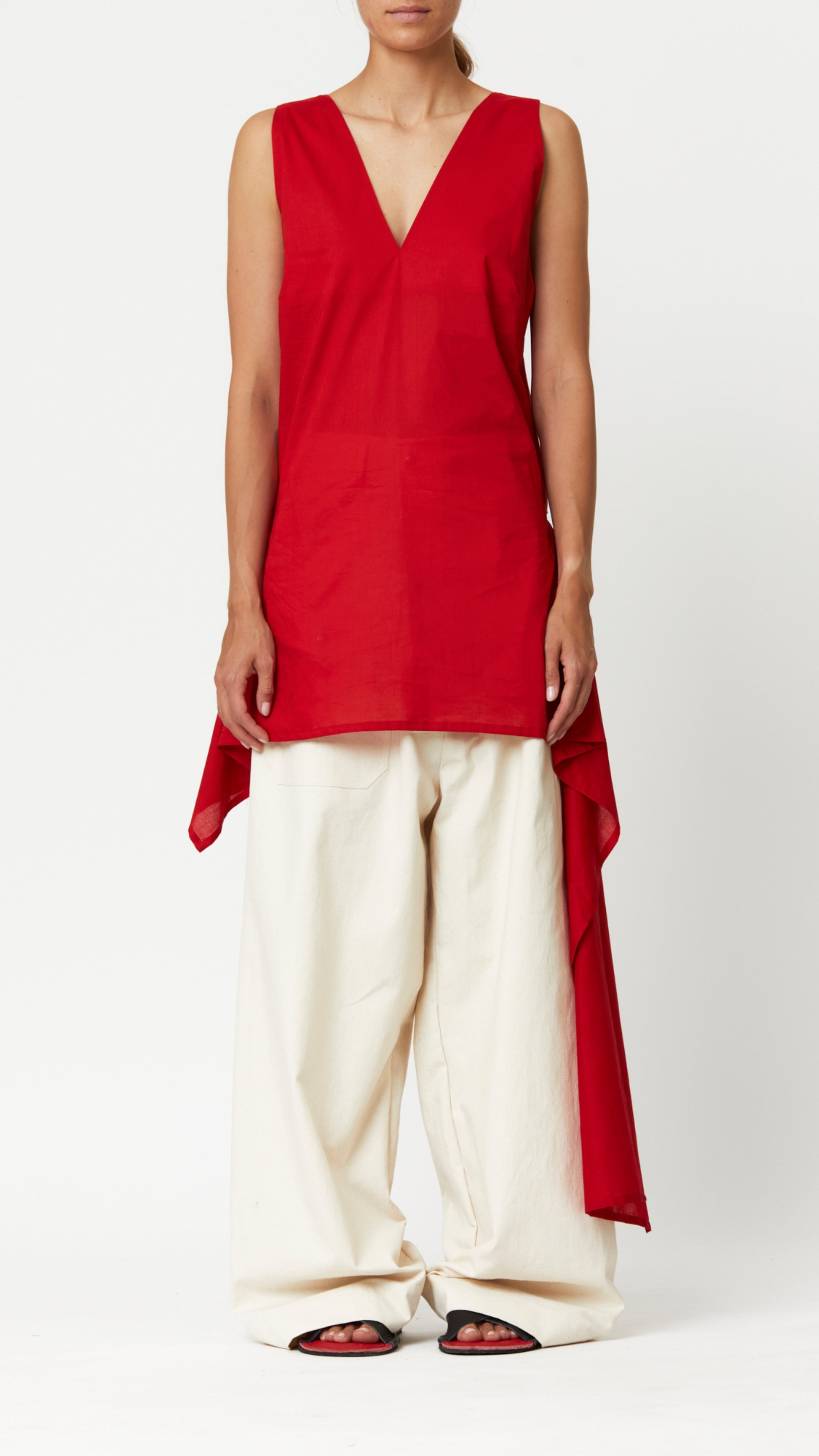 Plan C Tank Top in Fire Red Red cotton poplin long tank top style with v neckline and long side tail. It has an internal tie at the waist to wear more fitted or loose, Shown on model facing front.