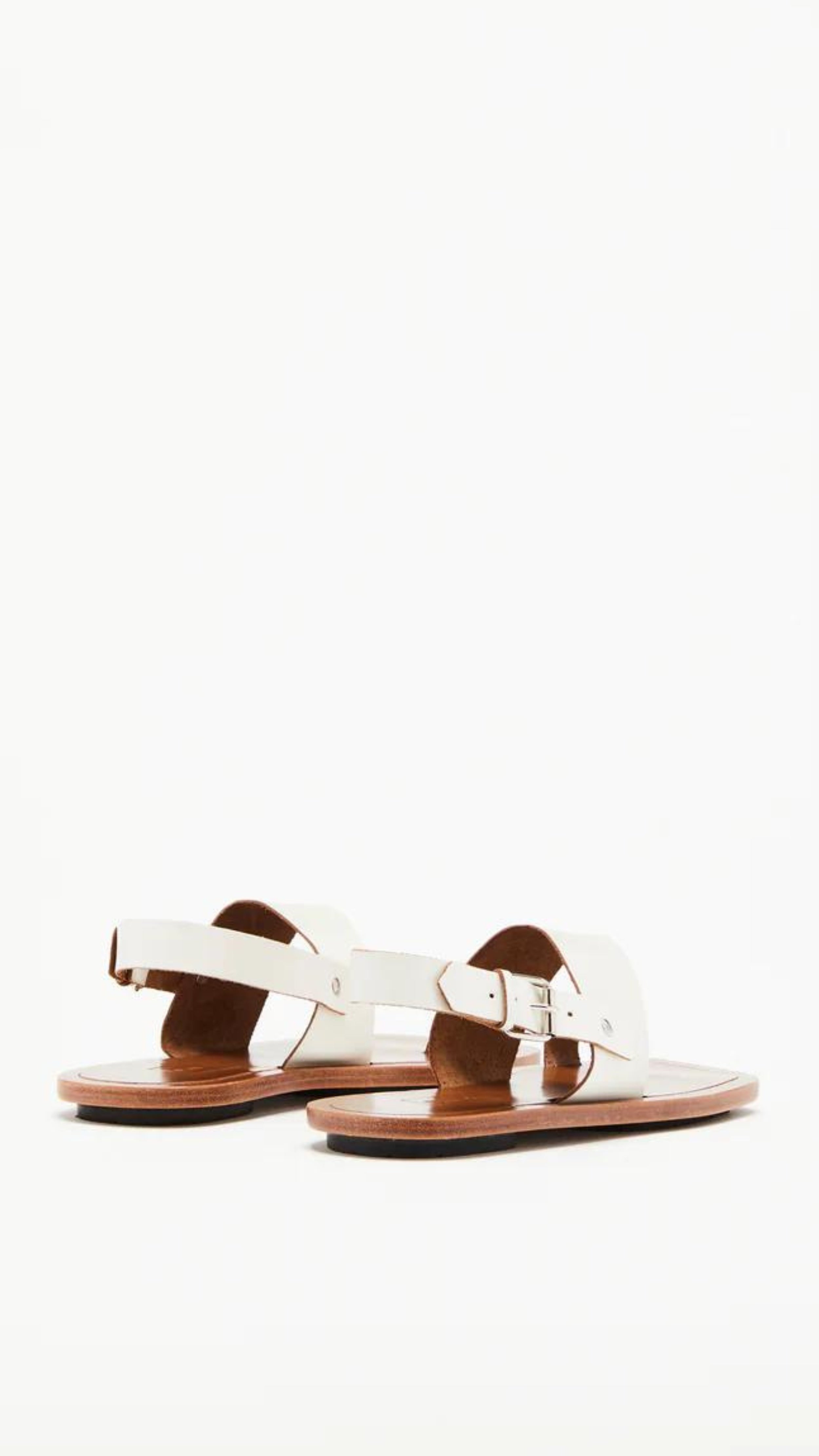 Plan C White Toe Ring Sandals. Made in Italy, these sandals have a strap across the foot, buckle around the heel and a ring of leather at the big toe. Flat sandals with a leather sole. Photo shown from the back.