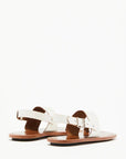 Plan C White Toe Ring Sandals. Made in Italy, these sandals have a strap across the foot, buckle around the heel and a ring of leather at the big toe. Flat sandals with a leather sole. Photo shown from the back.