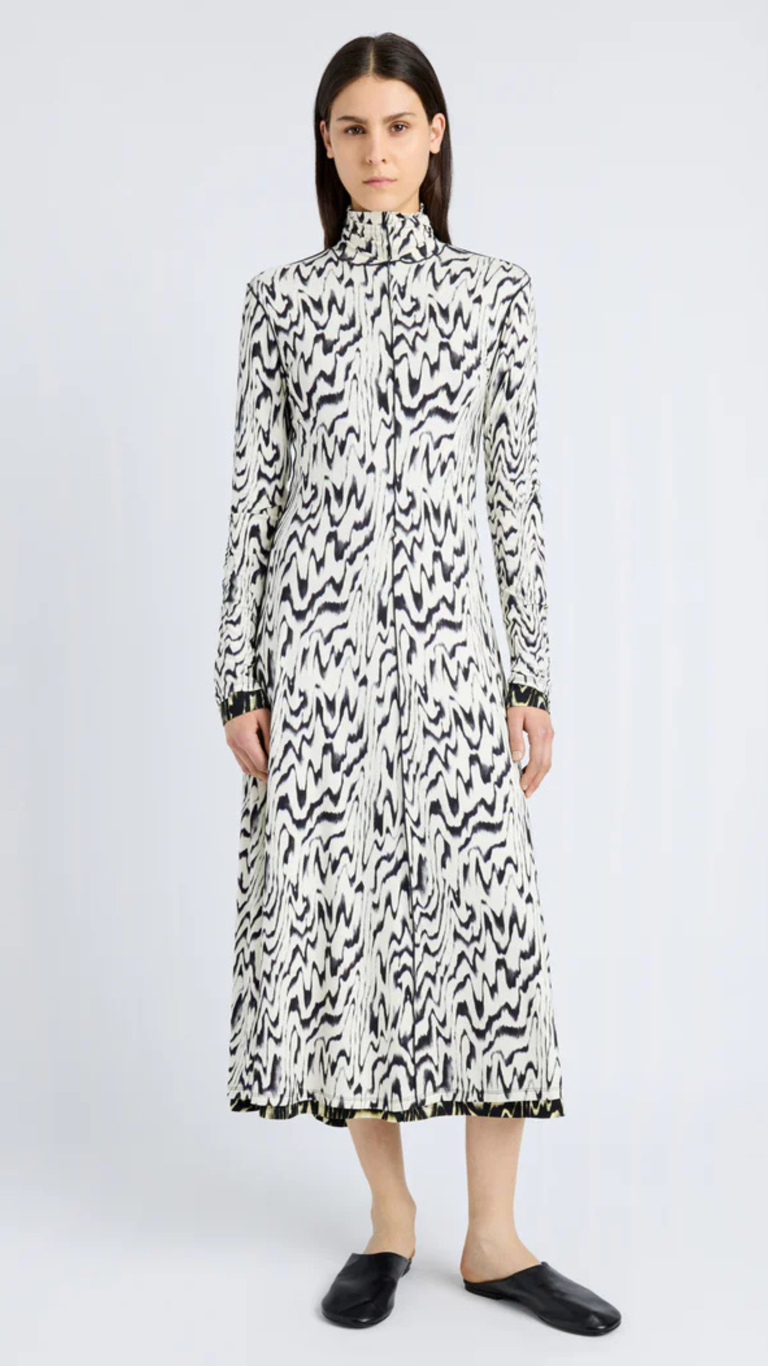 Marion dress in black and white abstract printed jersey with folded neck and long sleeves, featuring a sleek mid-length design.