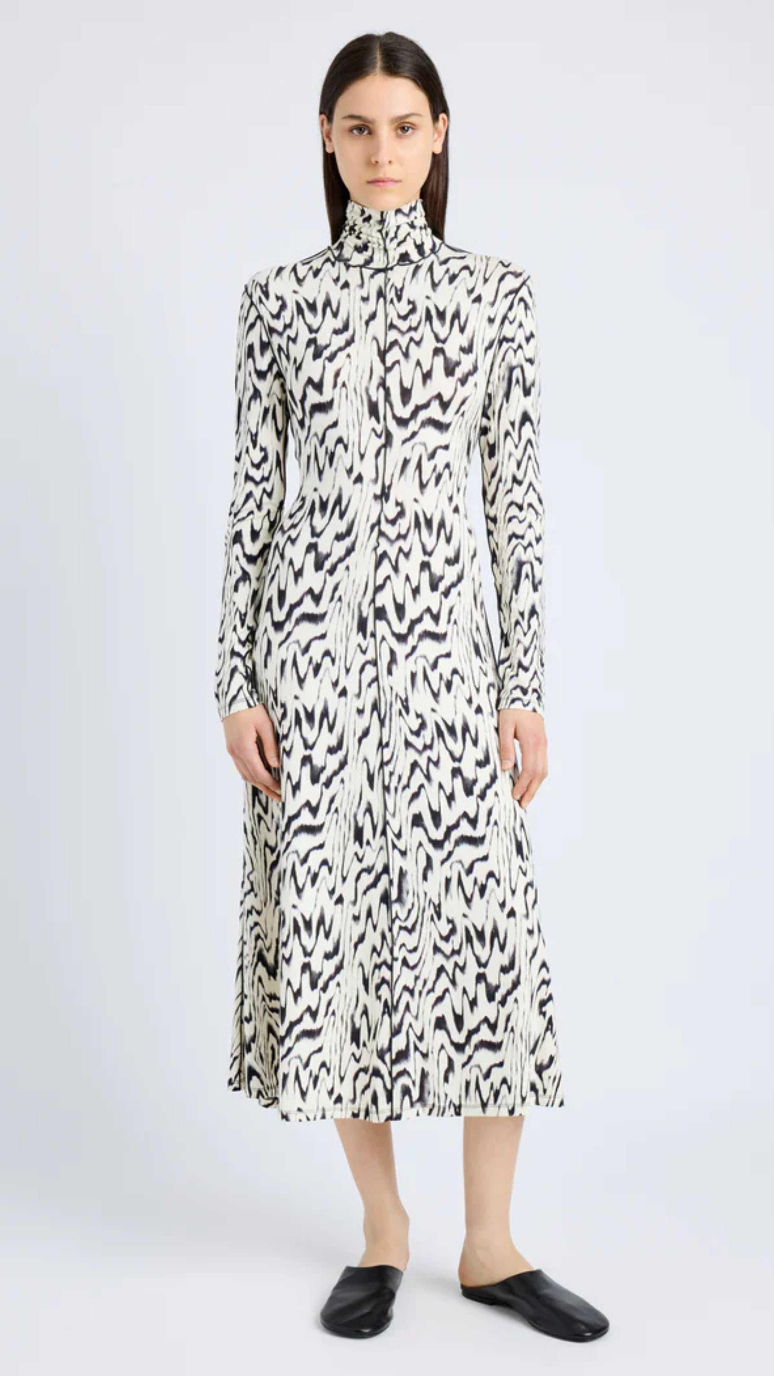 Marion Dress in printed jersey with black and white abstract design, featuring a folded neck and long sleeves by Proenza Schouler.