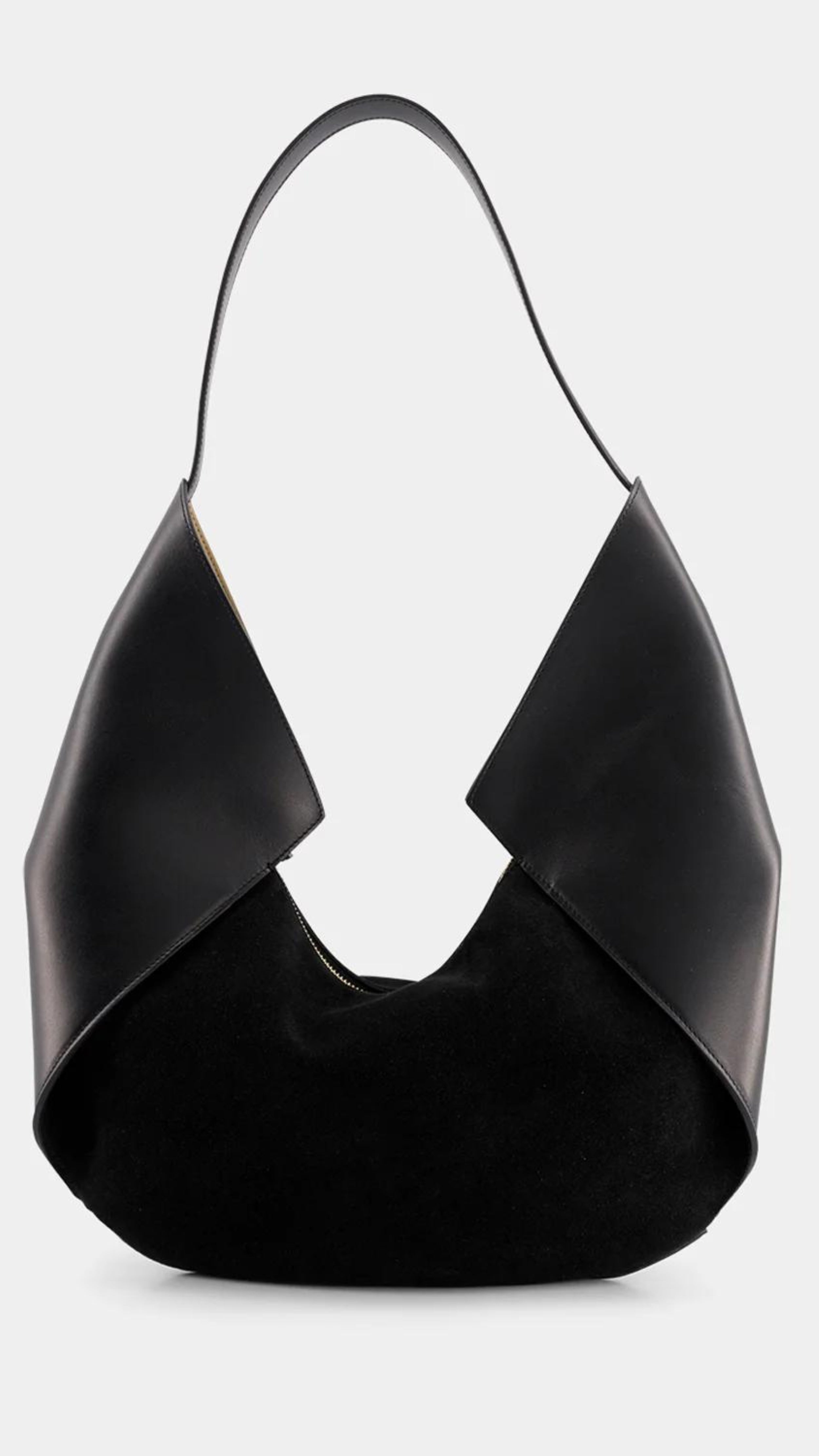 Ree Projects Riva Mini in Soft Calf and Suede in Black. Modern shaped soft black leather and suede purse. Small sized should bag with a zipper closure. Product photo from the front view.