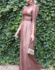 Rochas Paris Lame Creponne Gown. Bronze toned silk lame creponne with a mock neckline, cinched waist and pleated skirt that  falls to the ankle.  This dress has slightly heightened shoulder. Photo shows the model wearing the gown facing to the front side..