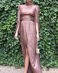 Rochas Paris Lame Creponne Gown. Bronze toned silk lame creponne with a mock neckline, cinched waist and pleated skirt that  falls to the ankle.  This dress has slightly heightened shoulder. Photo shows the model wearing the gown facing front.