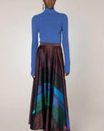 Roksanda Ameera Skirt in silk. Organic painted pattern of rich plum, blue and green colors. With a fitted band waist and hidden back zipper. This is a floor length skirt. Shown in the model facing front.