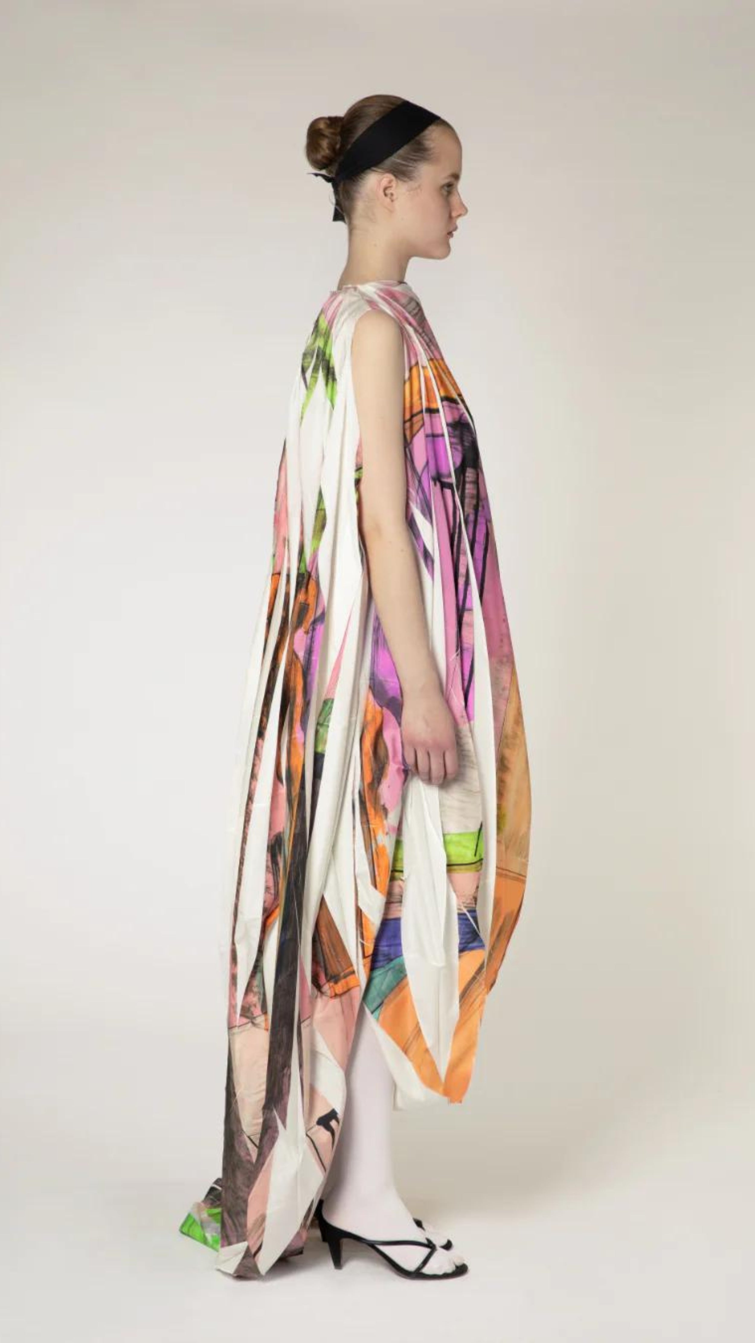 Roksanda Arletta Dress. Limited edition one of ten pieces created. Hand printed on parachute fabrics for an original pattern and designer of pinks, oranges, greens and white. Draped front with front belt and cape like back. Long maxi dress for evening gown looks. Shown on model facing side.