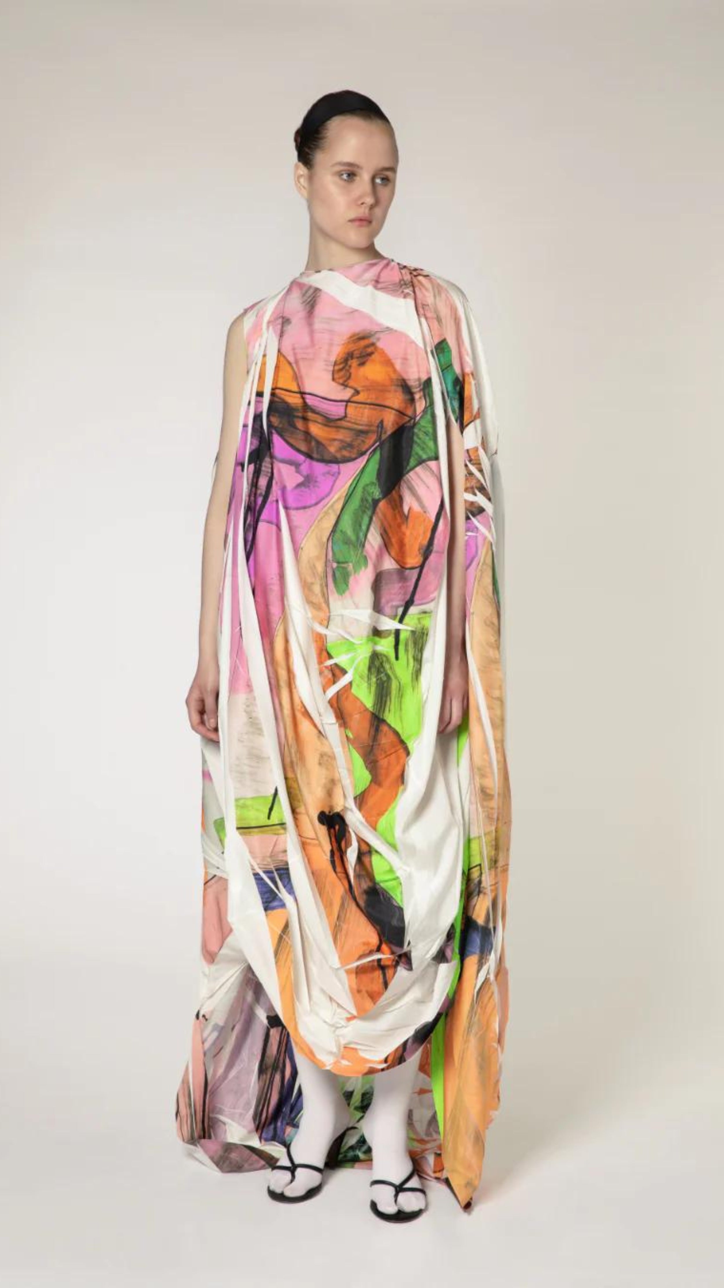 Roksanda Arletta Dress. Limited edition one of ten pieces created. Hand printed on parachute fabrics for an original pattern and designer of pinks, oranges, greens and white. Draped front with front belt and cape like back. Long maxi dress for evening gown looks. Shown on model facing front.