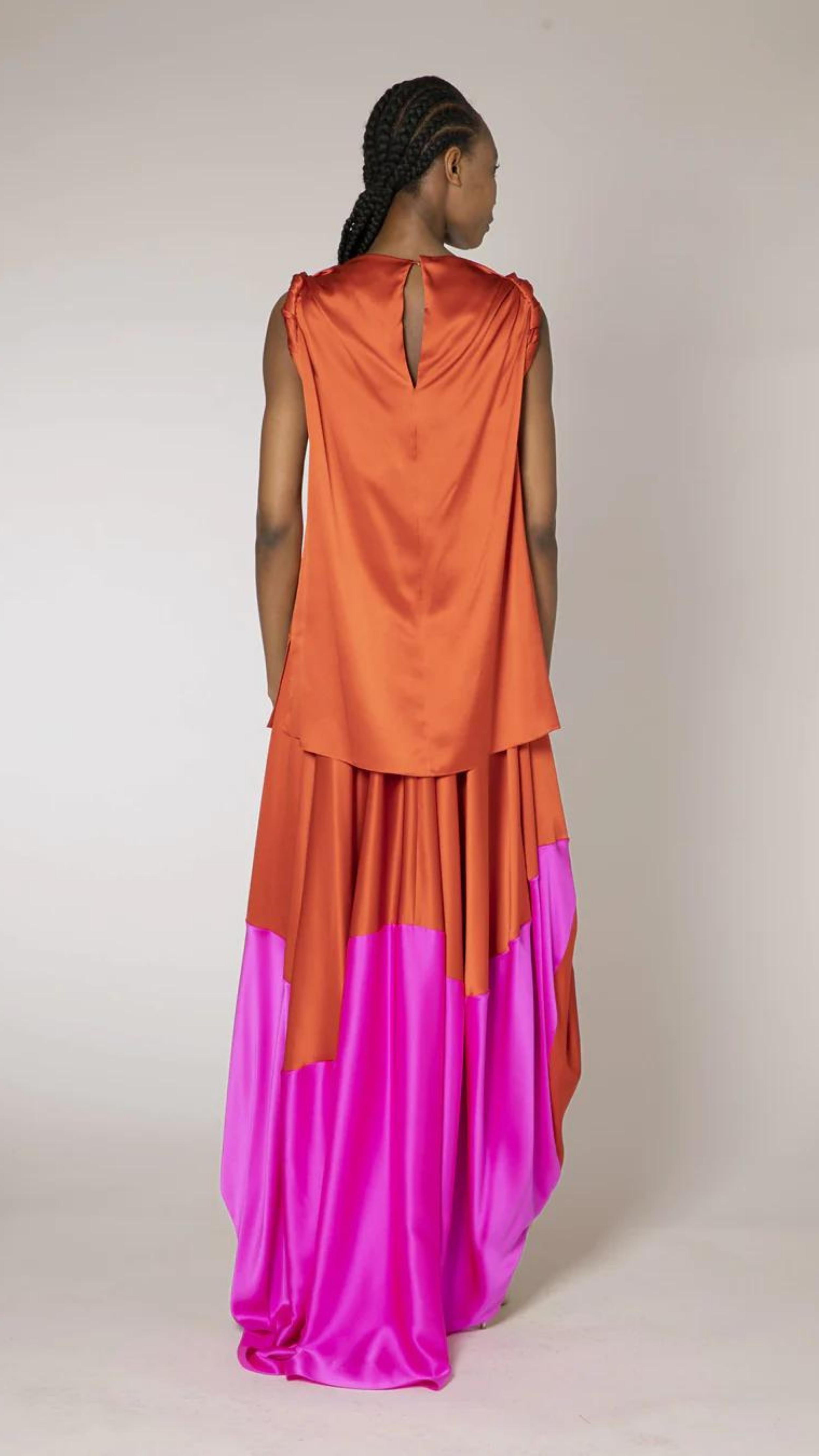 Roksanda Kali Top. Silk sleeveless top in deep rust orange color with braided arms. Long straight style. Shown on model with coordinating Kobi Skirt facing to the back.