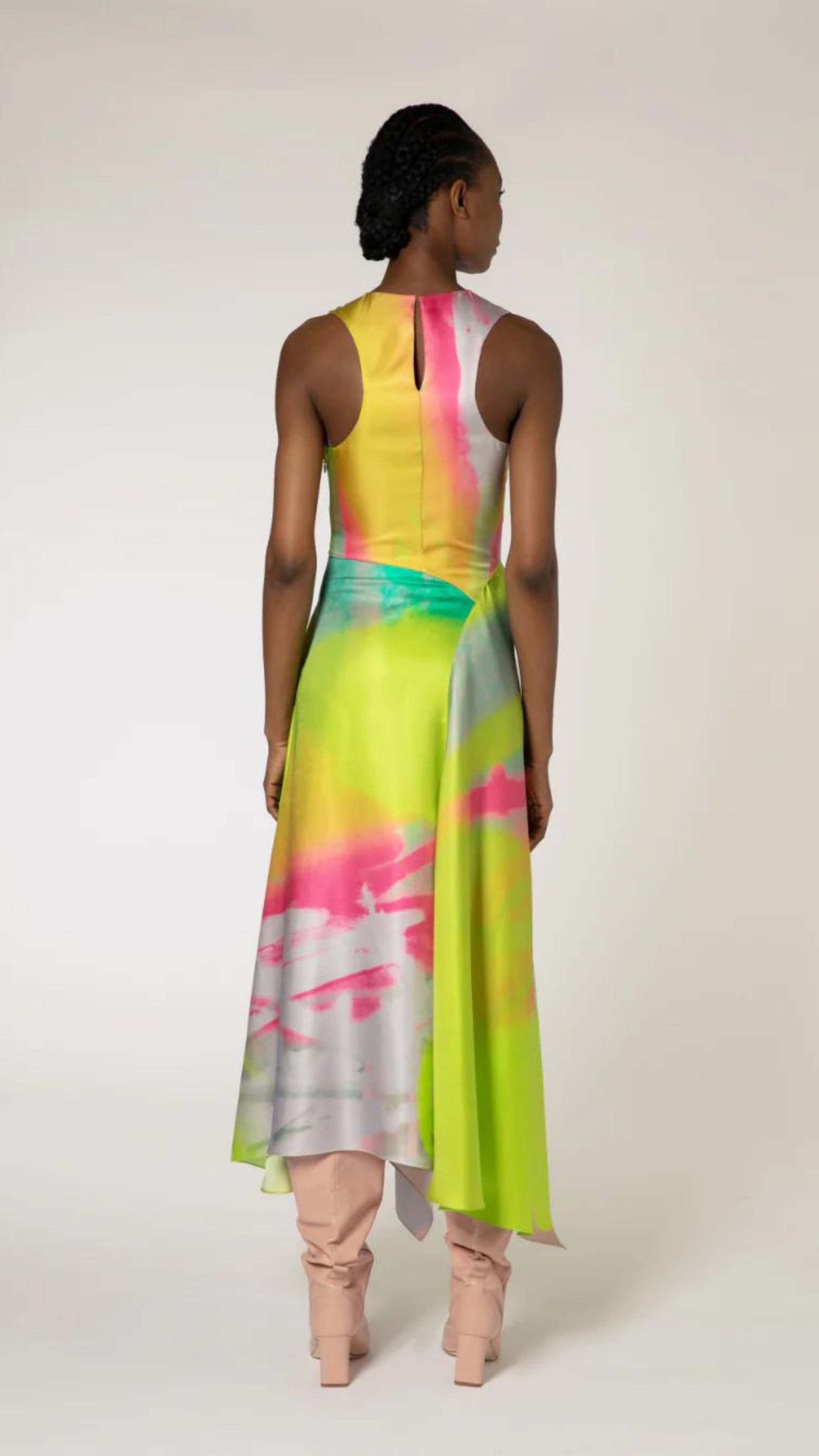 Roksanda Zenobia Dress. Fresh modern style silk twill dress in neon limes, pinks and soft blue. With an racer back style top, asymetrical dropped waist and midi length loose fitting skirt. Shown on model facing back.