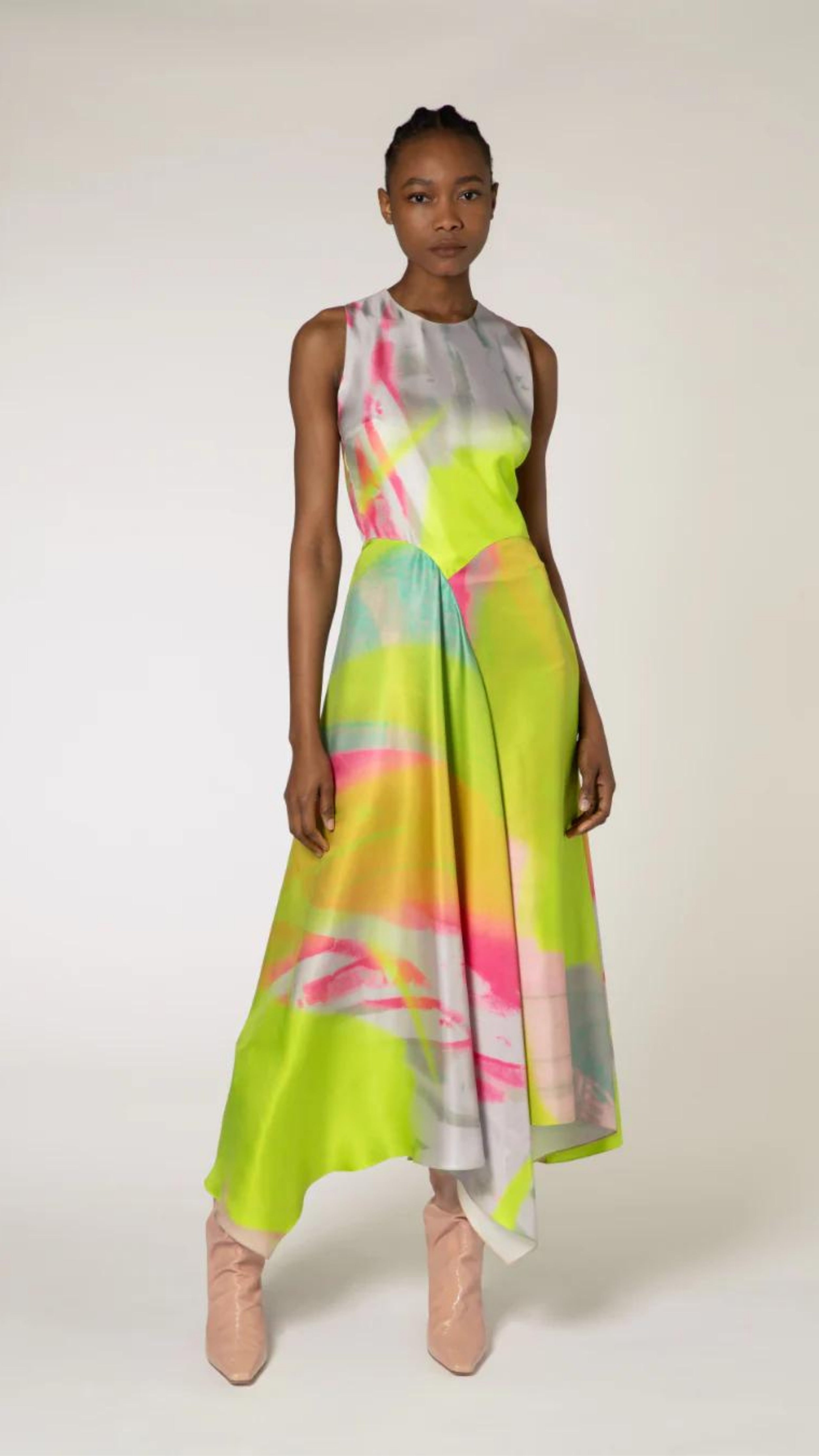 Roksanda Zenobia Dress. Fresh modern style silk twill dress in neon limes, pinks and soft blue. With an racer back style top, asymetrical dropped waist and midi length loose fitting skirt. Shown on model facing front.