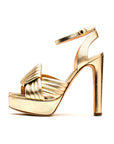 Rupert Sanderson, The Hellcat Heel Crafted in the highest quality Italian Nappa leather and complemented by a woven geometric pattern across the toes in a soft metallic gold color. The platform soles and ankle straps provide a secure fit to comfortably wear the 10cm heel.  One shoe shown in profile view.