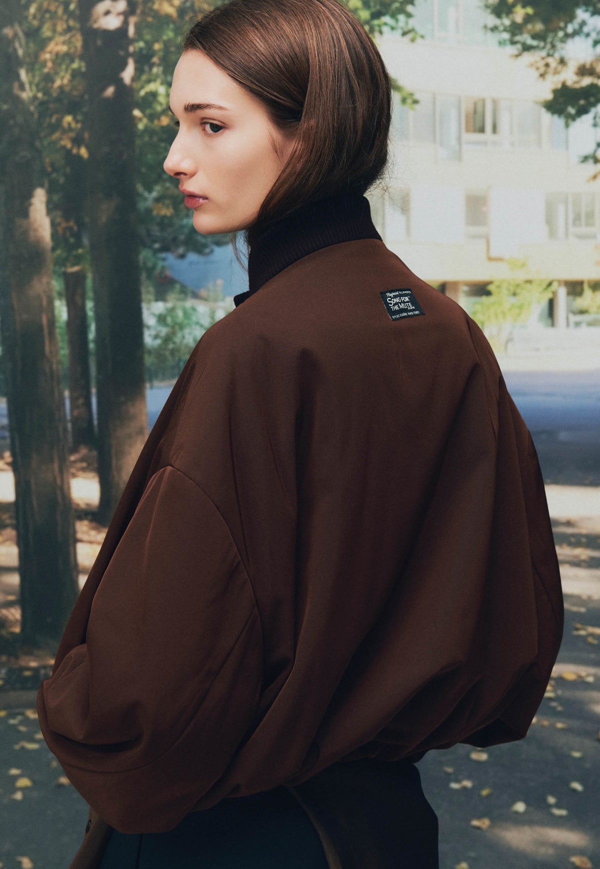 Song for the Mute Playground lookbook: back detail of a brown bomber jacket