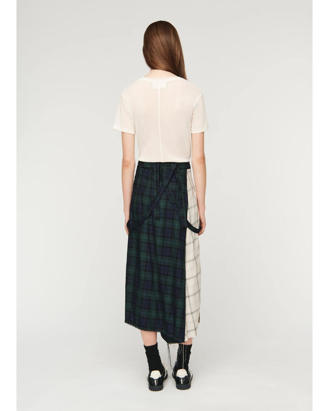 Song for the Mute Pleated Skirt in multi tartan check, back view on model showing panel construction and raw hem
