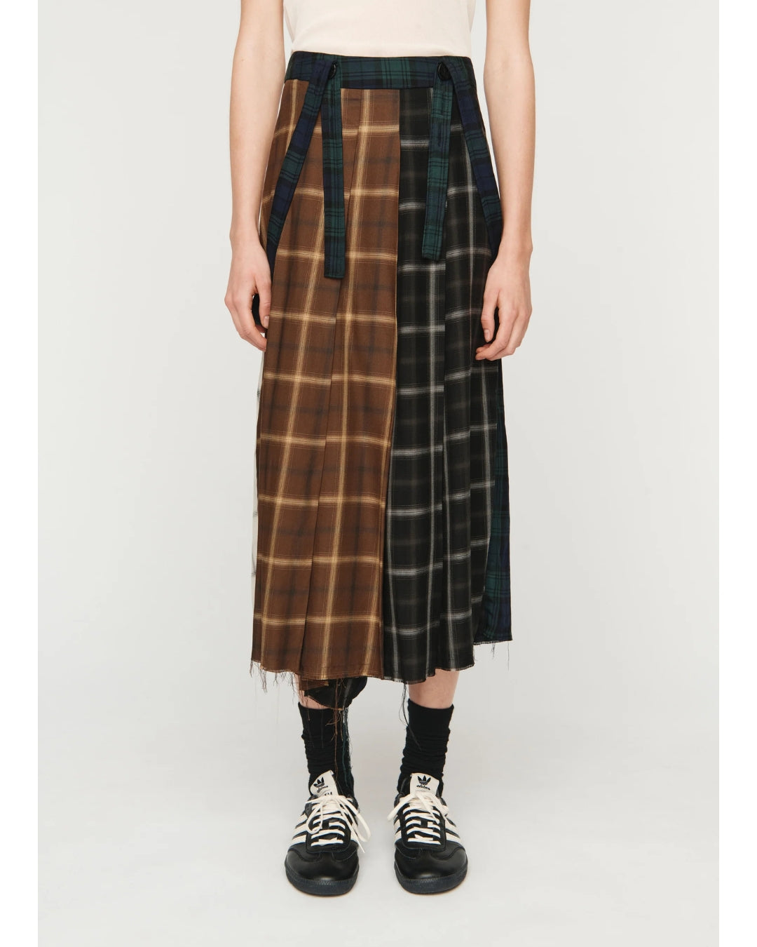 Song for the Mute Pleated Skirt, front view showing brown and dark check tartan panels